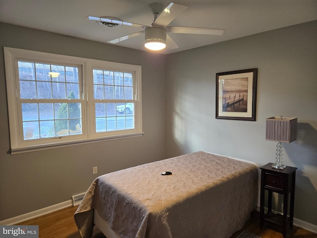 bedroom with ceiling fan and dark hardwood / wood-style flooring