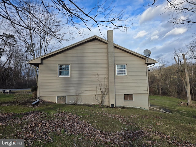 view of property exterior with a lawn