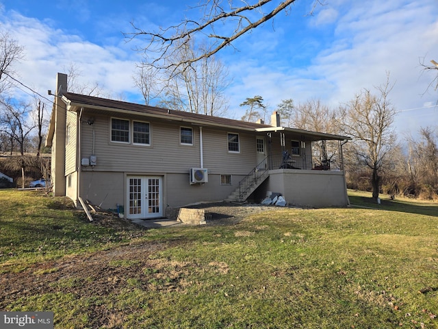 back of property featuring a lawn, a wall mounted AC, and french doors