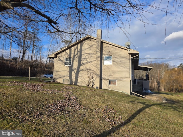 view of home's exterior with a yard