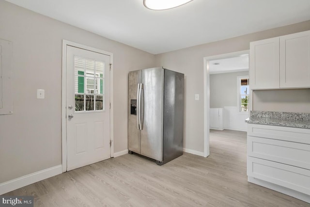 interior space with light hardwood / wood-style flooring and a wealth of natural light