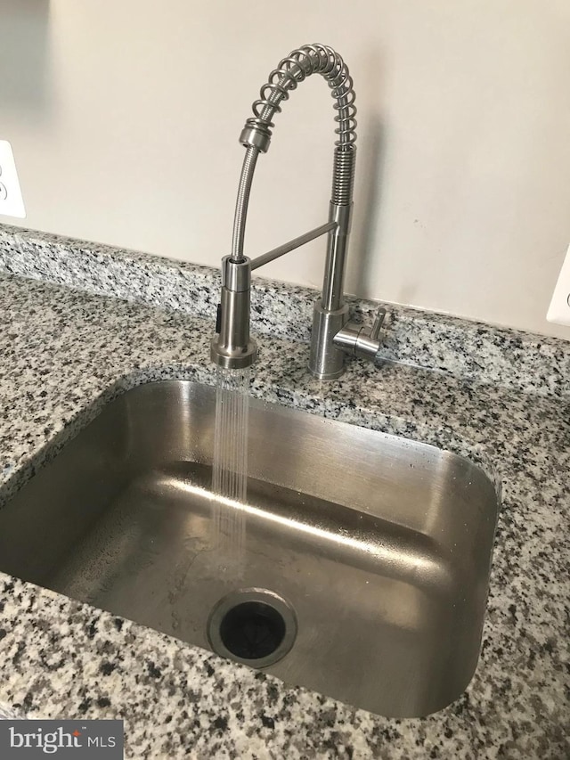 details featuring sink and stone countertops