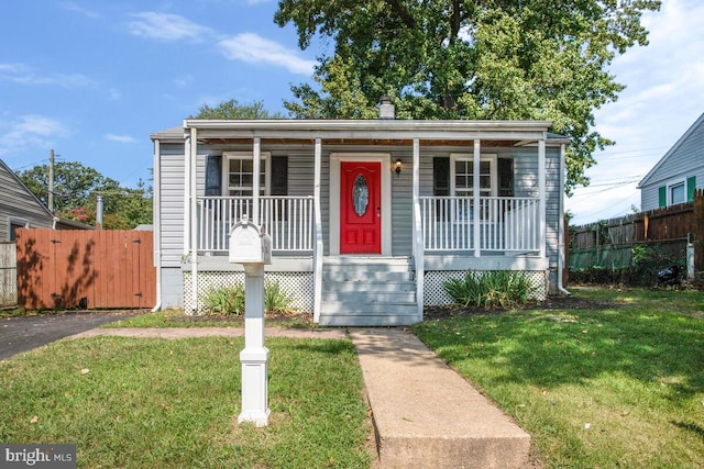 bungalow with a front yard and a porch