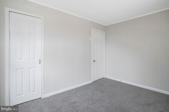 carpeted spare room with ornamental molding