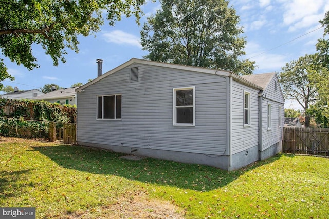 view of property exterior with a lawn