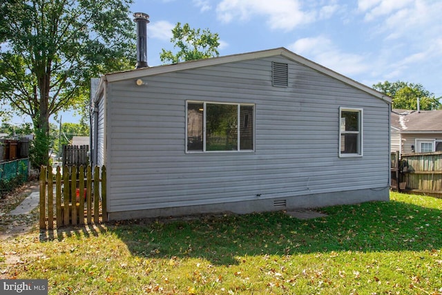 view of side of home featuring a lawn