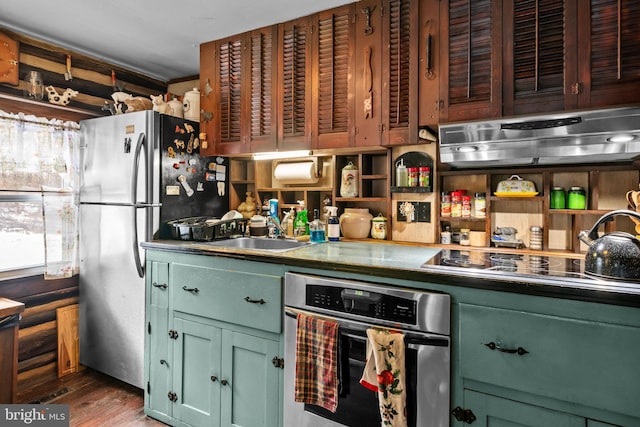 kitchen featuring appliances with stainless steel finishes, exhaust hood, dark hardwood / wood-style flooring, wooden walls, and sink