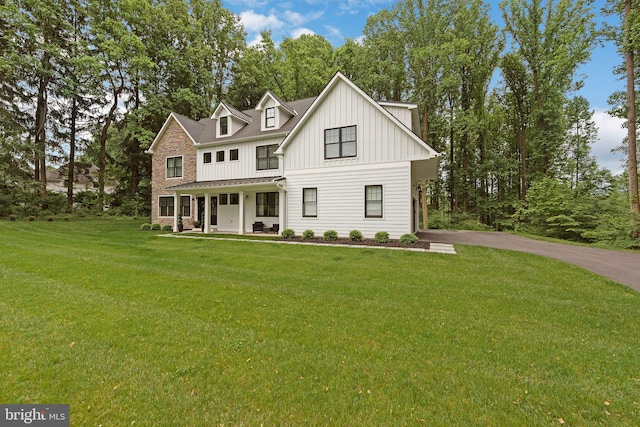 view of front of property with a front yard and covered porch