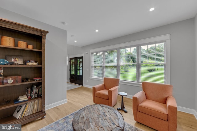 sitting room with french doors and light hardwood / wood-style floors