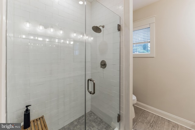 bathroom featuring an enclosed shower and toilet