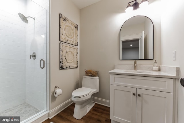 bathroom featuring vanity, toilet, wood-type flooring, and walk in shower