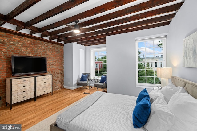 bedroom with light hardwood / wood-style flooring and beamed ceiling