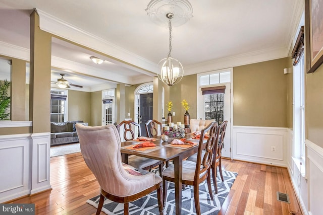 dining space featuring light hardwood / wood-style flooring, plenty of natural light, and crown molding