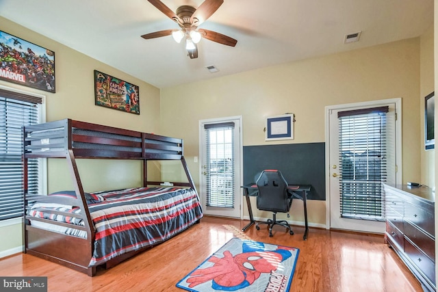 bedroom with access to outside, ceiling fan, and wood-type flooring