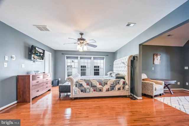 bedroom with ceiling fan and light hardwood / wood-style floors