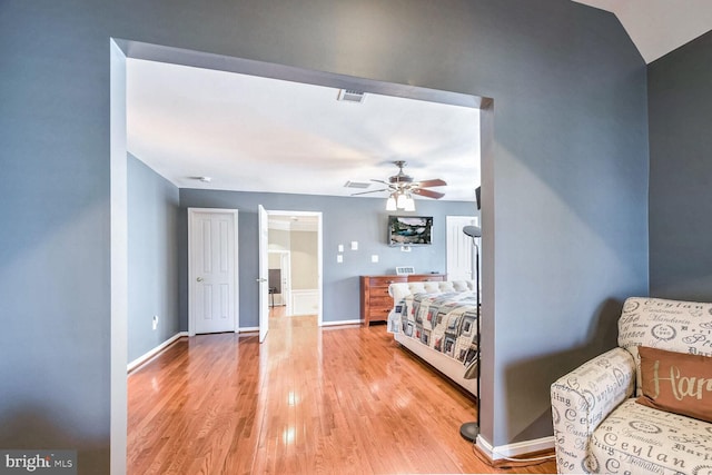 unfurnished bedroom featuring light hardwood / wood-style flooring, ceiling fan, and lofted ceiling