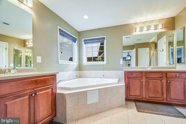 bathroom featuring tile patterned floors, separate shower and tub, and vanity