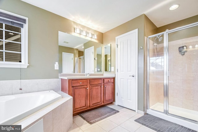 bathroom with tile patterned flooring, vanity, and independent shower and bath