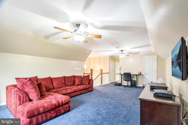 carpeted living room with ceiling fan and vaulted ceiling