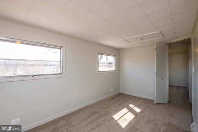 unfurnished bedroom featuring carpet flooring and baseboards