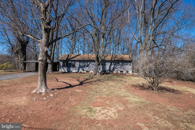 view of front of home with a carport and driveway