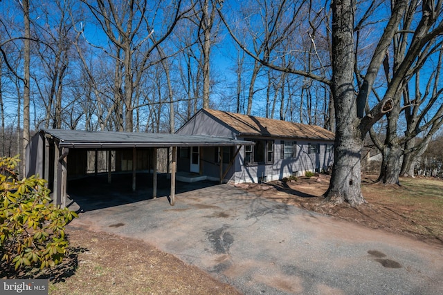view of front of property with aphalt driveway and an attached carport