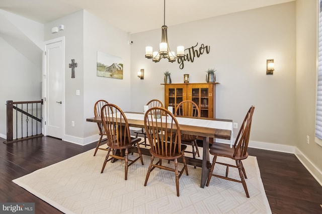 dining room with an inviting chandelier, baseboards, and wood finished floors