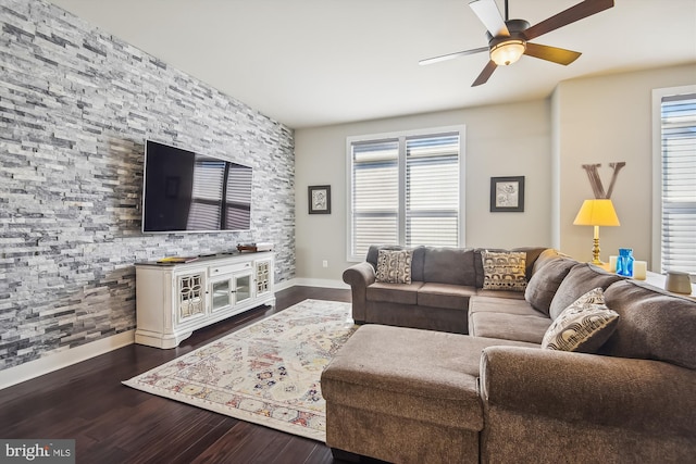 living room with ceiling fan and dark wood-type flooring