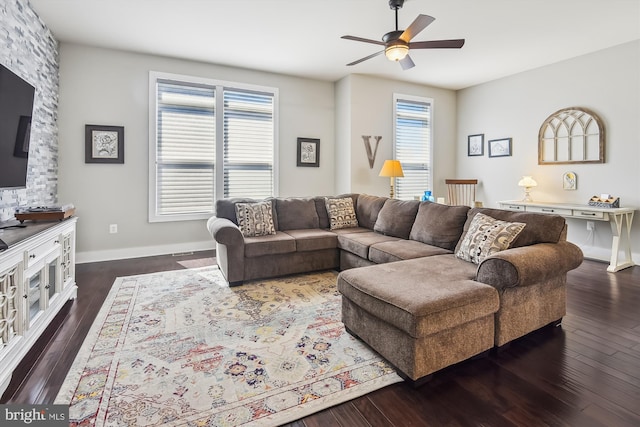 living area with dark wood finished floors, baseboards, and ceiling fan