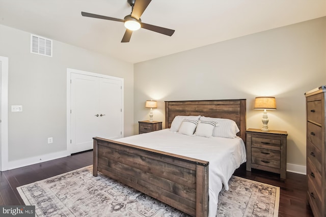 bedroom featuring ceiling fan, visible vents, baseboards, and dark wood finished floors