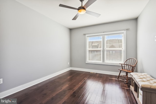 unfurnished room with dark wood finished floors, baseboards, and ceiling fan