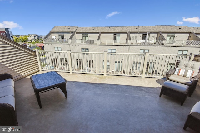 view of patio with a balcony and a residential view