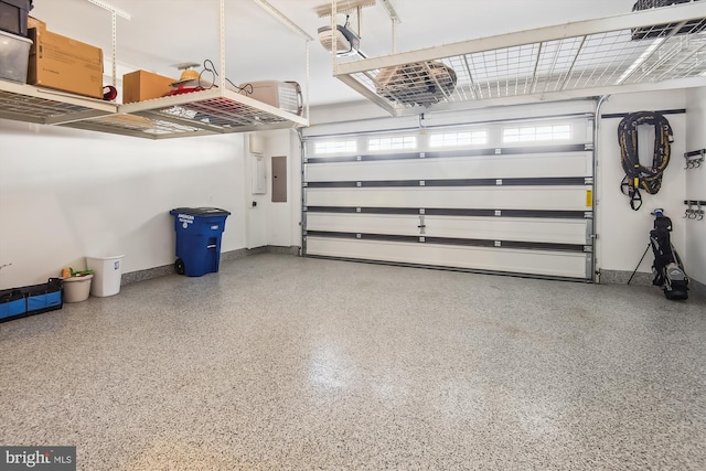 garage featuring electric panel and a garage door opener