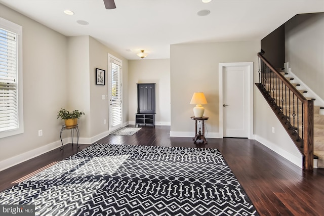 entryway featuring ceiling fan, a healthy amount of sunlight, and dark hardwood / wood-style flooring