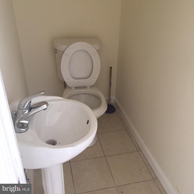 bathroom with tile patterned flooring and toilet