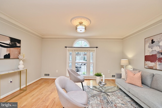 living room featuring light hardwood / wood-style floors and ornamental molding