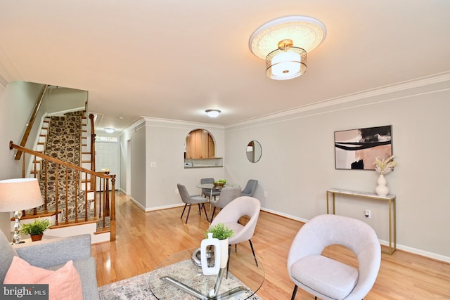 living room with crown molding and hardwood / wood-style flooring