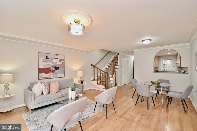 living room with light hardwood / wood-style floors and ornamental molding