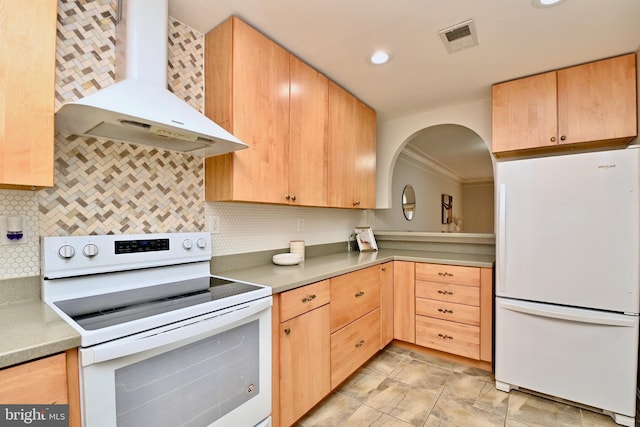 kitchen featuring backsplash, wall chimney exhaust hood, and white appliances