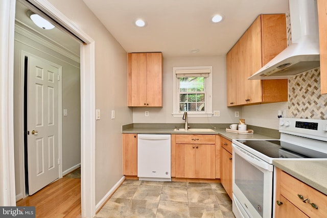 kitchen with light brown cabinetry, tasteful backsplash, wall chimney exhaust hood, white appliances, and sink