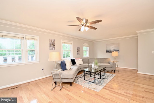 living room featuring light wood-type flooring, ceiling fan, and crown molding