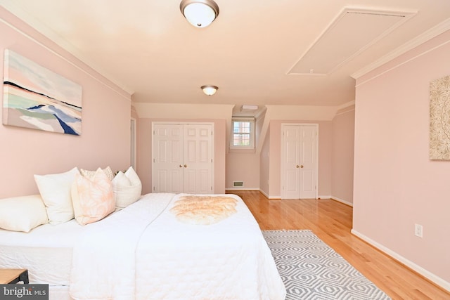 bedroom featuring crown molding and light hardwood / wood-style flooring