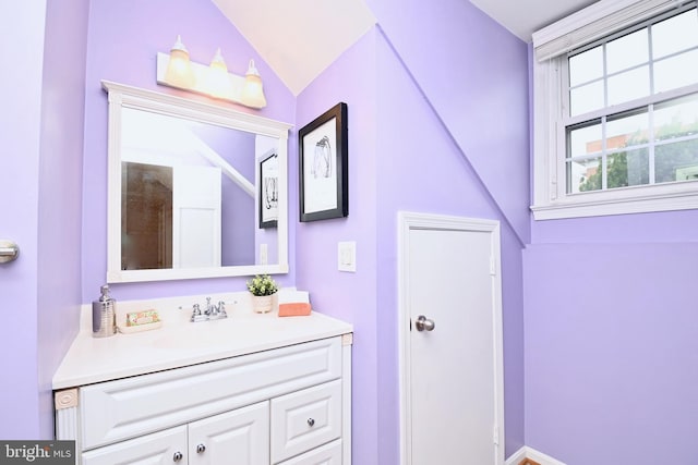 bathroom featuring vanity and vaulted ceiling