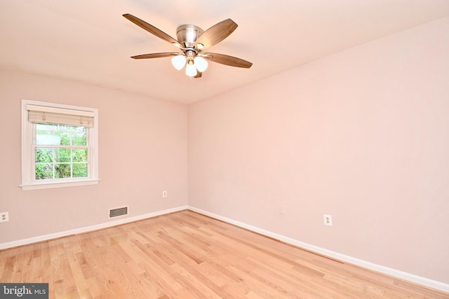 empty room with light hardwood / wood-style flooring and ceiling fan