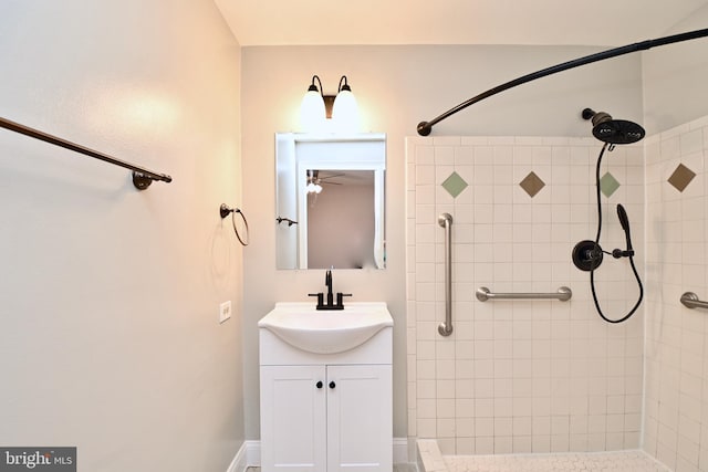 bathroom with vanity and tiled shower