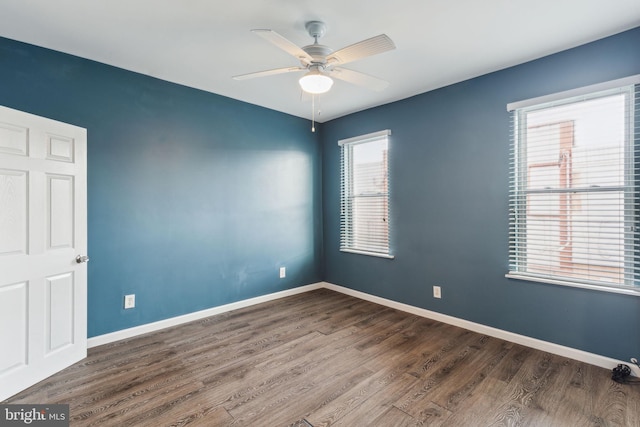 empty room featuring ceiling fan and dark wood-type flooring