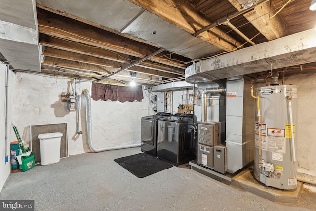 basement featuring washer and dryer, electric panel, gas water heater, and heating unit