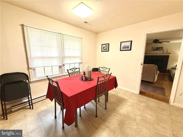 dining space with ceiling fan and a baseboard radiator