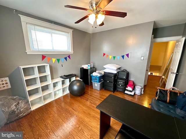 home office featuring hardwood / wood-style floors and ceiling fan