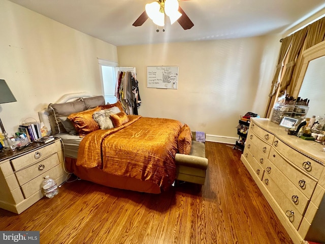 bedroom featuring ceiling fan and dark hardwood / wood-style flooring